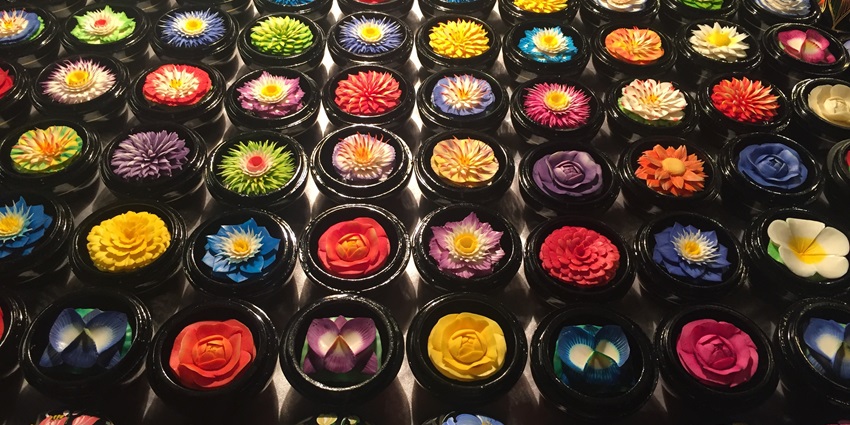 Multiple handmade soap carvings with flowers carved on them, both a utility and a visually - appealing product.