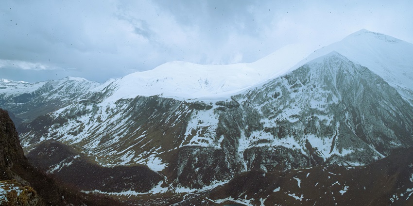 Snow-covered trail & icy mountains are among the top adventurous things to do in Kazbegi.