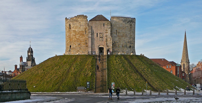 Clifford’s Tower in York, offering historical insights, is accessible via staircase with informative panels along the way.