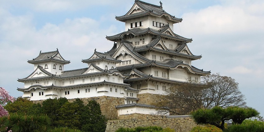 Himeji Castle with traditional Japanese architecture and surrounded by lush greenery