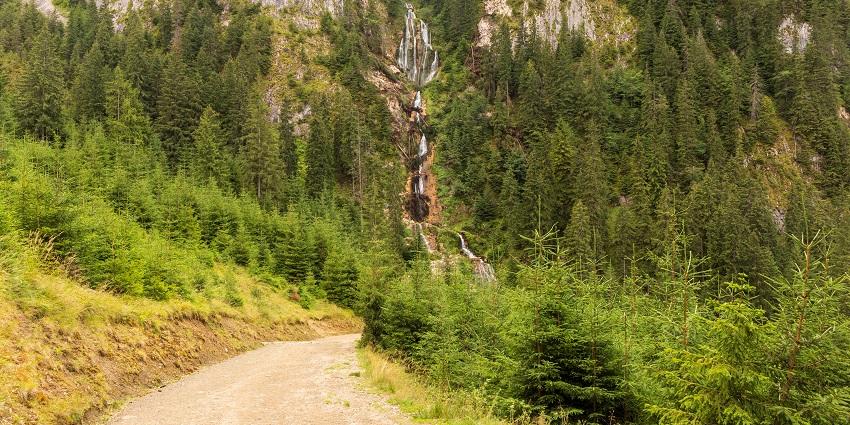 Water is powerfully tumbling down the rocky cliffs at Cascada Cailor in Romania’s hills.
