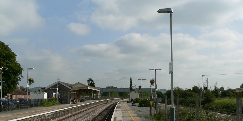 Castle Cary railway station with railway tracks, distant station buildings, platforms and lights