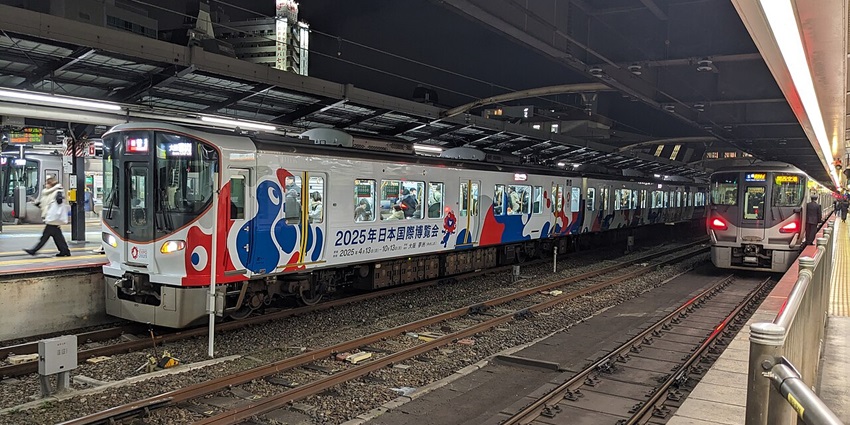 Tennoji station in Osaka with World Expo 2025 train, people in the train and platforms