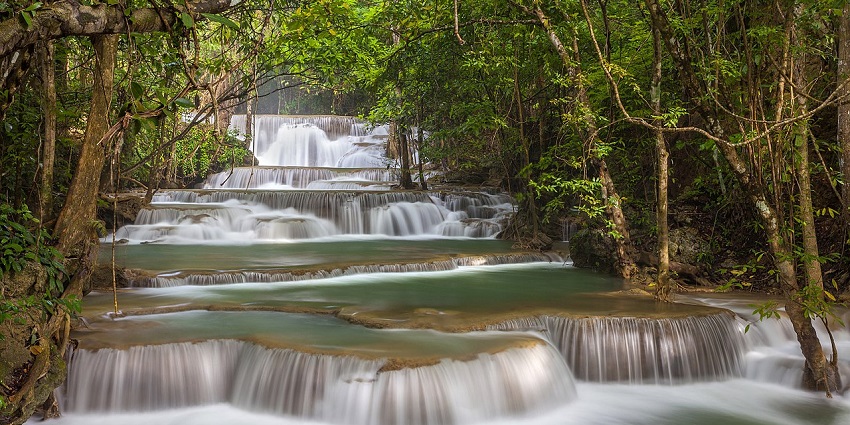Huai Mae Khamin Waterfall cascading through lush greenery, one of the scenic waterfall.
