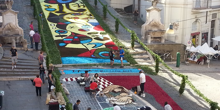 Intricate flower petal mosaics are arranged on streets for the Infiorata flower festival