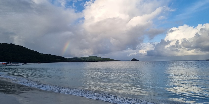 A view of Calaguas Island's white sand beach and clear blue waters in Camarines Norte