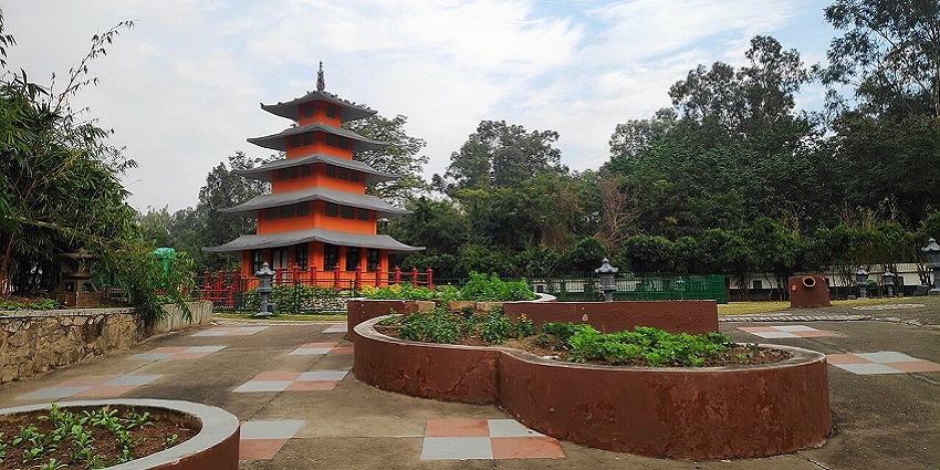 Visitors walking and relaxing in the peaceful Japanese Garden with greenery and water features