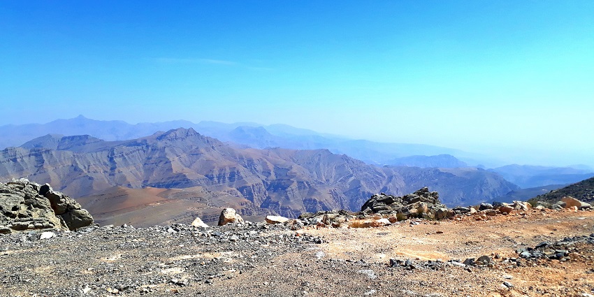 The breathtaking view of the Jebel Jais Mountain beneath a blue sky in the Ras Al Khaimah region.