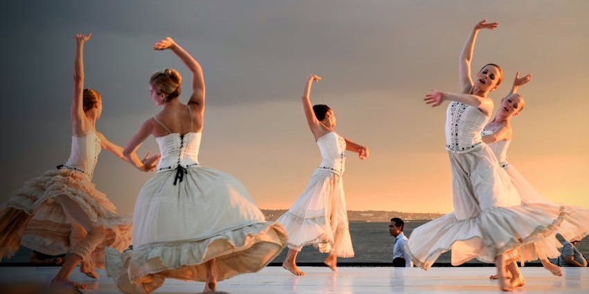 Performers showcasing dance style on the stage during a vibrant dance festival.