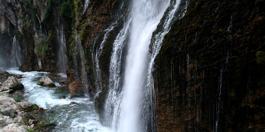 View of one of the Waterfalls in Turkey flowing down from rocky cliffs under strong pressure.
