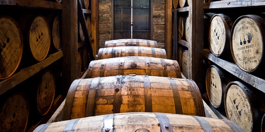A variety of bourbon bottles displayed on shelves, highlighting popular American spirits—perfect souvenirs among top things to buy in US.