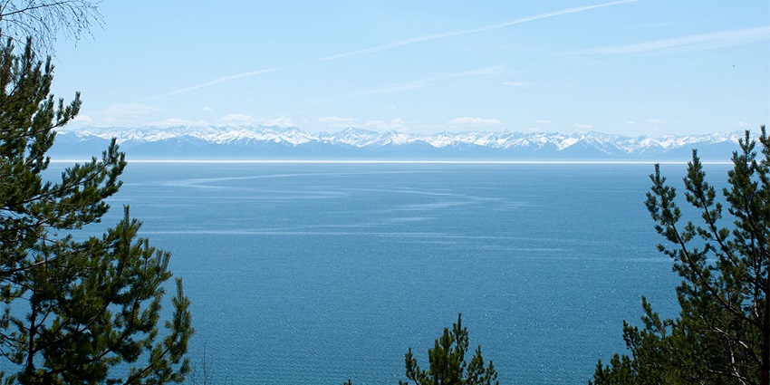 A distant view of the Khamar-Daban mountain range, in the foreground is Lake Baikal.