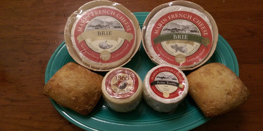 Charming Blue Heron French Cheese Company with outdoor seating and lush gardens.