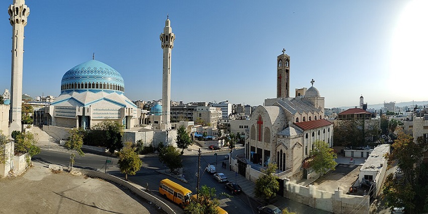 An image showing King Abdullah I Mosque alongside Our Lady Church in a city landscape setting.