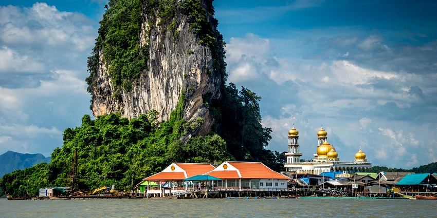 A floating fishing village with stilt houses, seafood restaurants, and cultural richness.