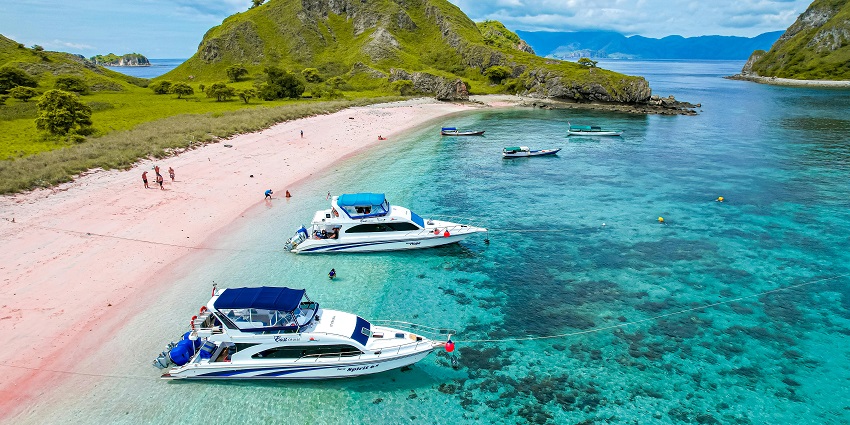 Padar Island’s curved bays and rugged hills under golden sunset light near Komodo Island.
