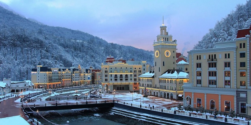 An aerial view of Krasnaya Polyana with an impressive building in the foreground.