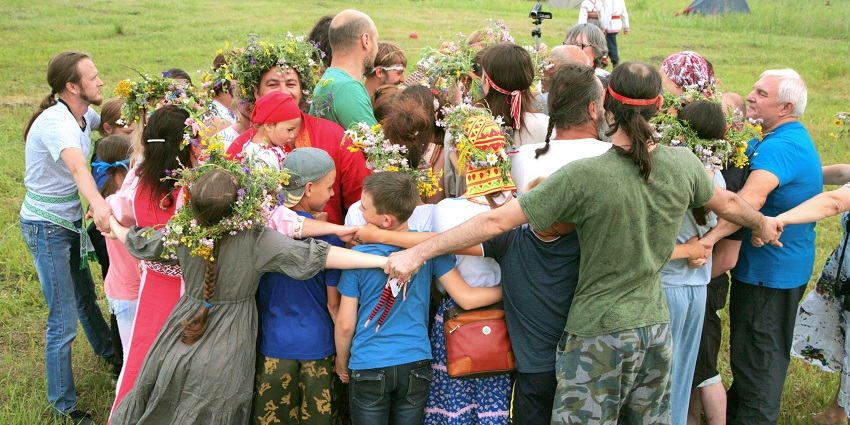 People celebrate Kupala Night with traditional costumes, a flower crown, and dance at festivals in Ukraine.