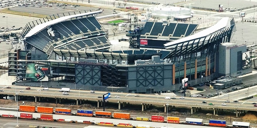 Lincoln financial field from above with modern architecture and vehicles parked nearby