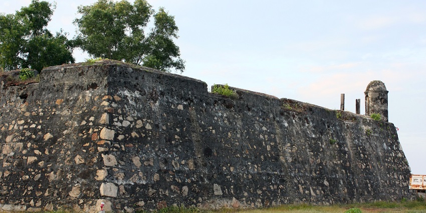View of the walls of Batticaloa Fort surrounded by trees and green fields