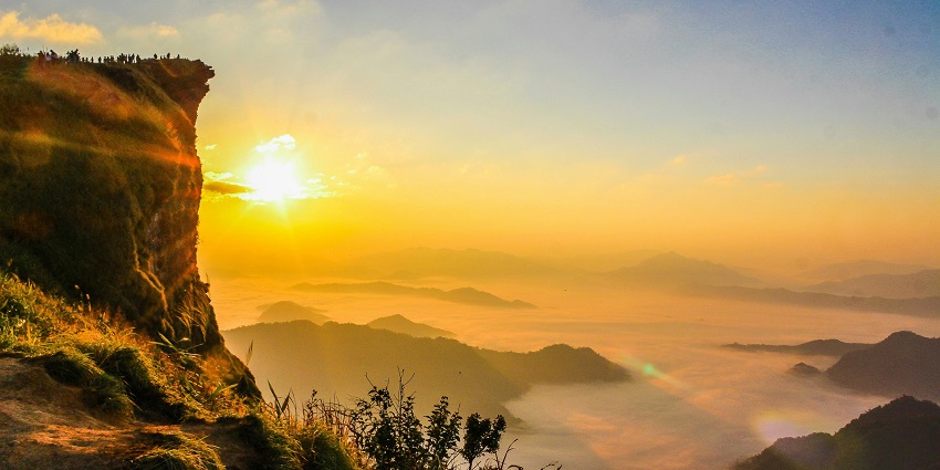 Witness stunning sunrise views from Phu Chi Fa Mountain, where misty cliffs and rolling hills create a magical morning atmosphere.