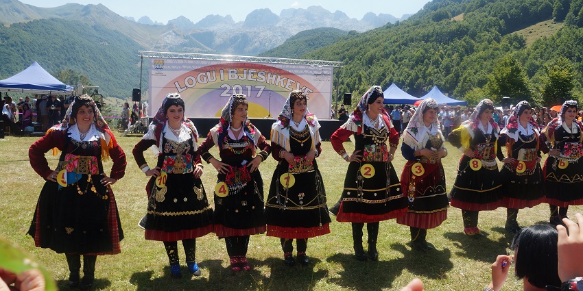 Traditional costumes and folk celebrations in a scenic mountain setting in northern Albania.