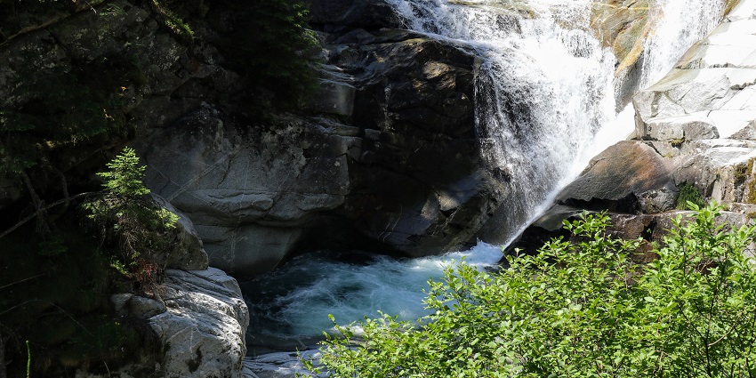 The Fallbach Waterfall in Maltatal plunges down a steep rock into a lush valley in the Austrian Alps.