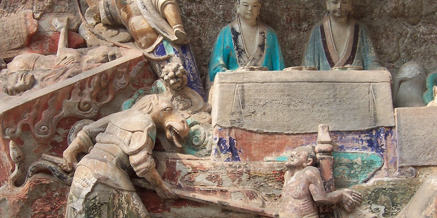 An ancient site with stunning Buddhist carvings and sculptures set against a dramatic cliff face.