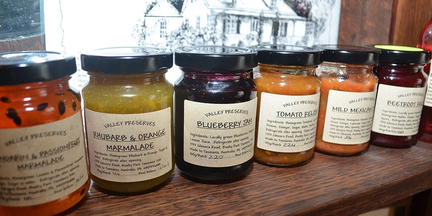 A variety of traditional Mauritian treats, jams, and chutneys, displayed on a table for a family gathering.