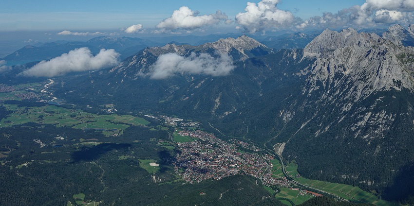 An aerial view of Mittenwald that includes Lake Lautersee and the peak Westliche Karwendelspitze, one of the best hill stations in Germany.