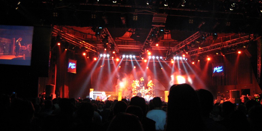 The audience enjoys a live concert with bright lights at the Montreux Jazz Festival stage.