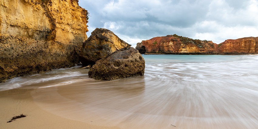 Waves crashing on the rocky shore of Morawala Beach near Negombo Lagoon at sunset