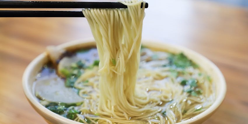 An image of a noodle dish resembling Nom Banh Chok, the best food in Cambodia.