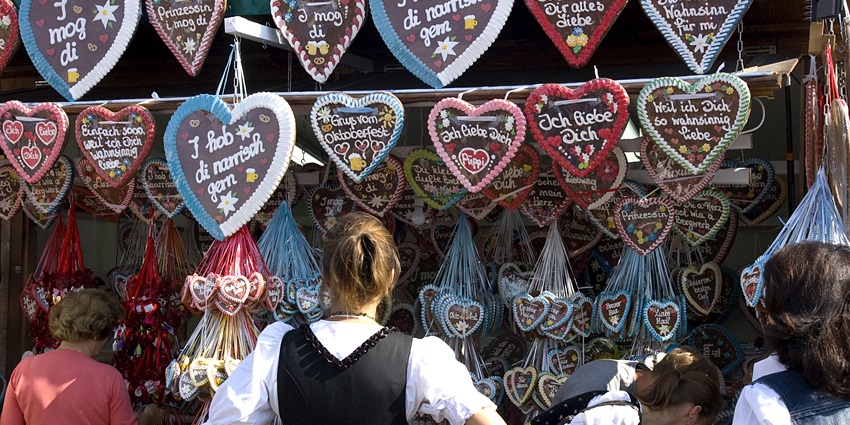 Image of München - Oktoberfest shops and people buying Souvenirs - one of the best things to have