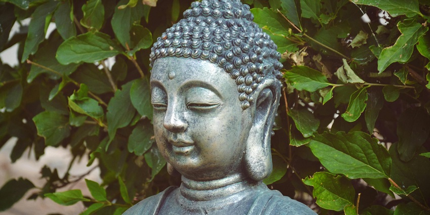 View of the statue surrounded by lush trees, an ideal spot for nature lovers