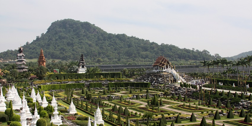 Wide angle view of the green landscape and small temples in thr garden