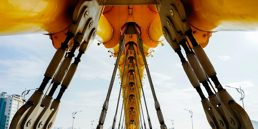 Dragon Bridge seen from the side with its golden body arching over the Han River.