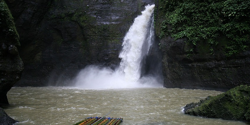 Rafts floating in the pool of Pagsanjan Falls, Laguna, surrounded by lush greenery
