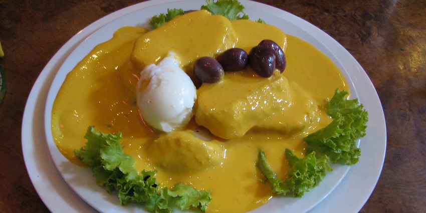 An image of Papas a la Huancaína, boiled potatoes with sauce, among the top foods in Peru