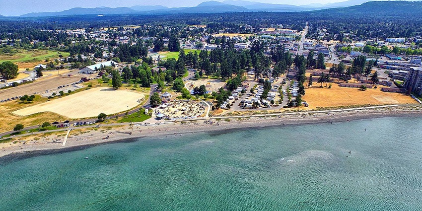 Expansive sandy beaches of Parksville with clear blue skies, a coastal place to visit near Vancouver.