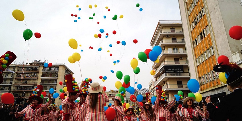 People enjoying festivals in Greece with colourful costumes at the Patras carnival, & releasing balloons.