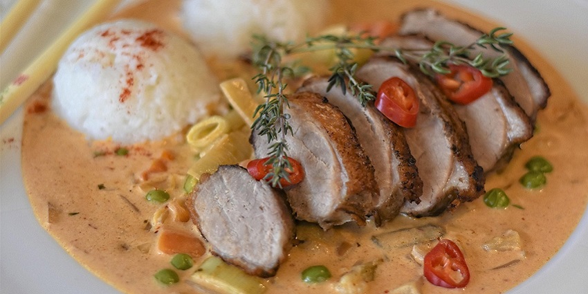 An image of Pečená kachna, roasted duck served with dumplings and cabbage.