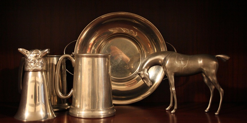 An image showing a view of elegant Malaysian pewter jugs and plates on display.