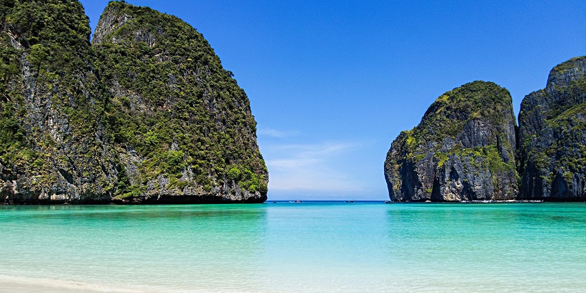 Tourists enjoy snorkelling in the turquoise waters of Phi Phi Islands, places to visit near krabi.