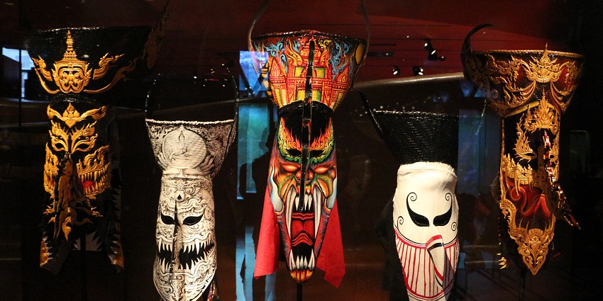 Asian art pieces are displayed in the Musée du quai Branly with soft gallery lighting