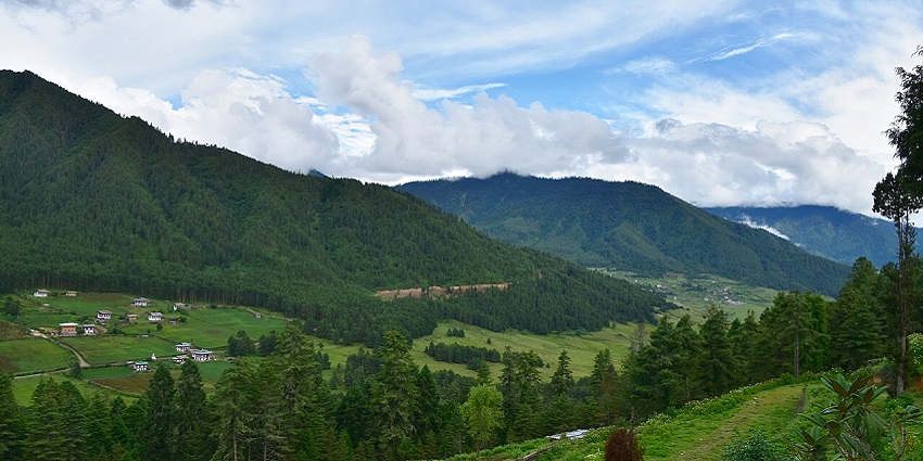 Phobjikha Valley's open grasslands and low hills with minimal vegetation are visible.