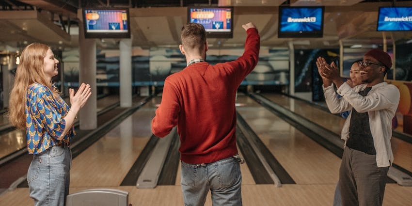 A group of students celebrating their win at a top bowling site, Ajax 5 Pin Bowling Centre