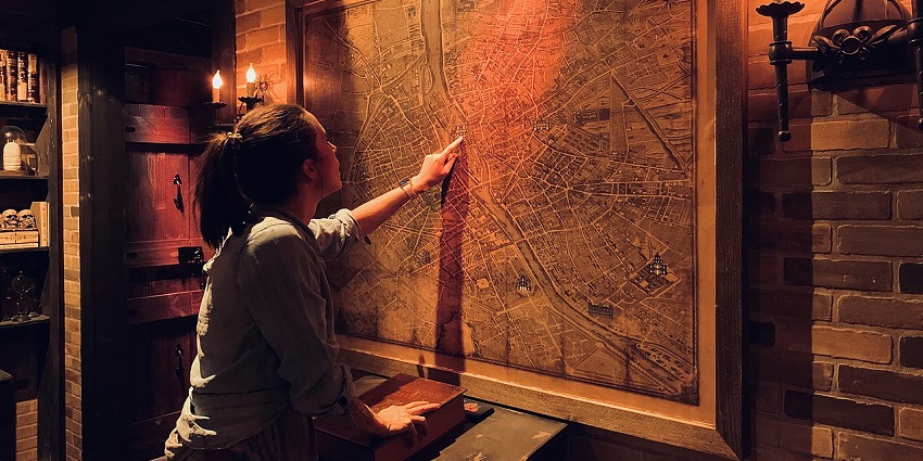 A girl solving a puzzle to escape the room, among exciting things to do in Buford, GA.