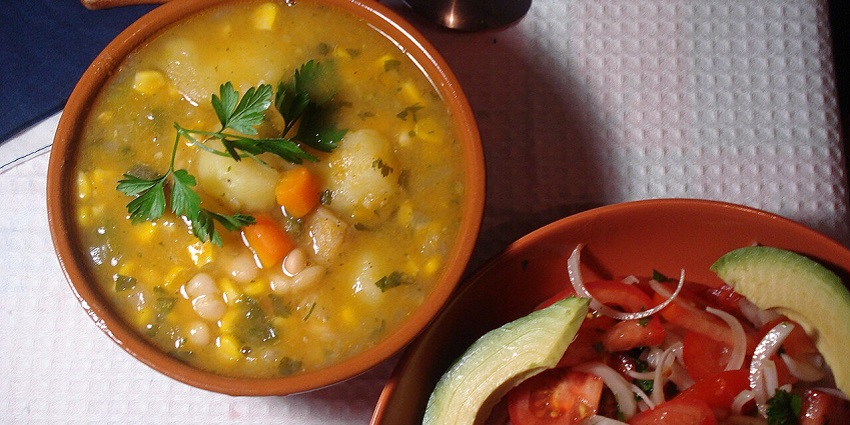 An image of Porotos Granados, a bean stew with corn and vegetables, a famous food in Chile.