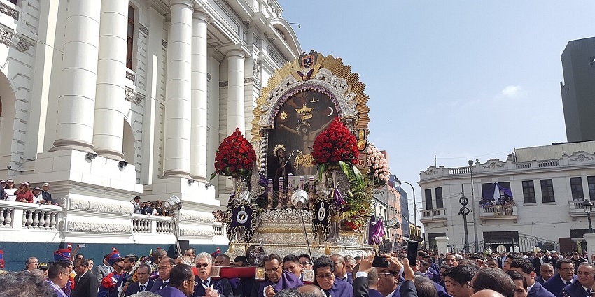 Believers in purple robes follow a sacred image through Lima, honoring one of festivals in Peru.